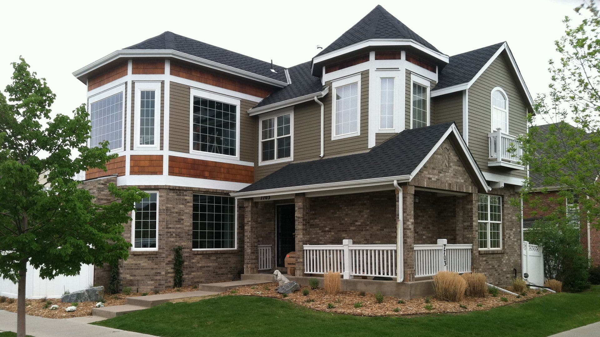 Two-story home exterior with new siding and stone