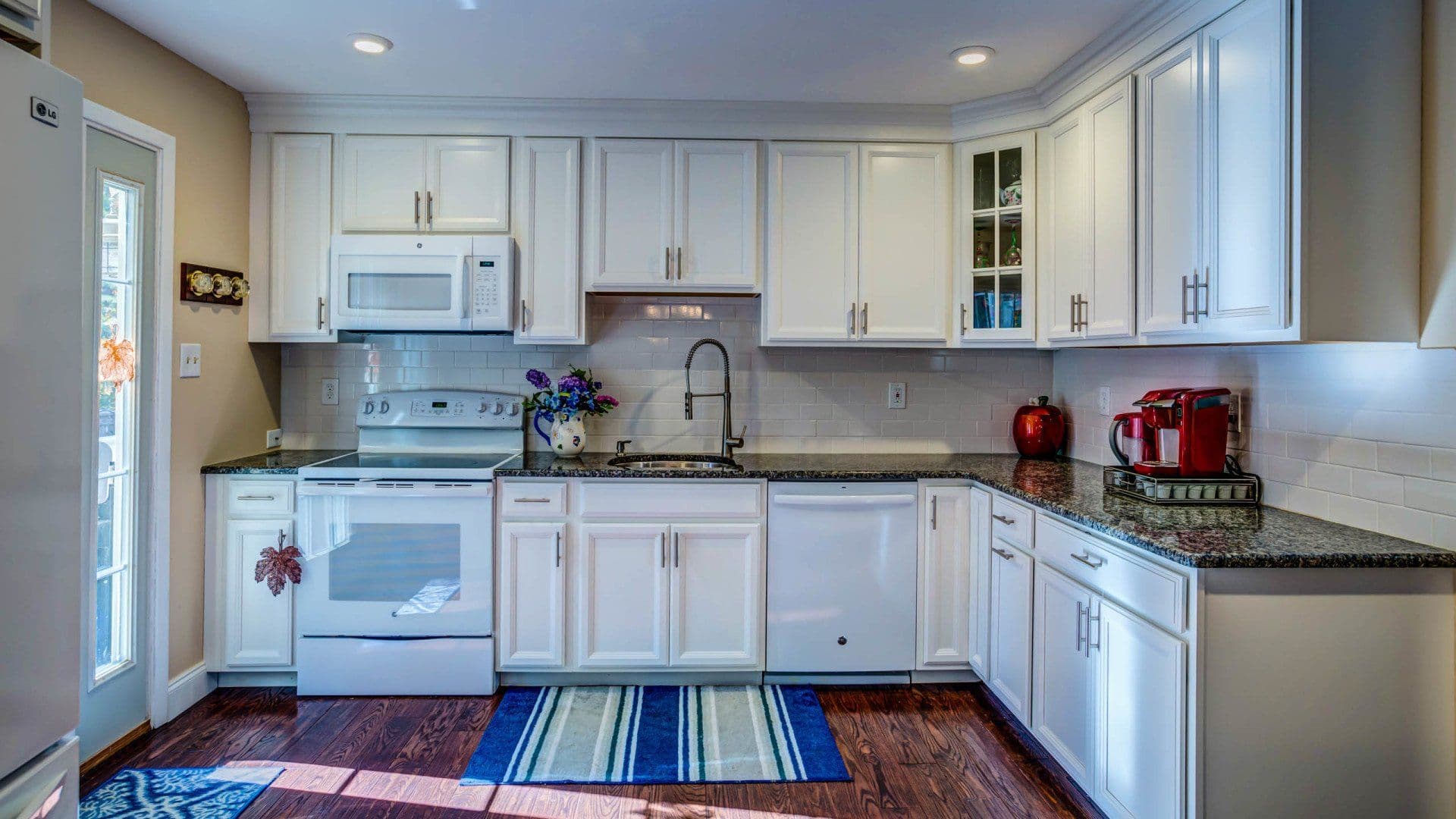 Rebuilt kitchen with white cabinets and granite counters